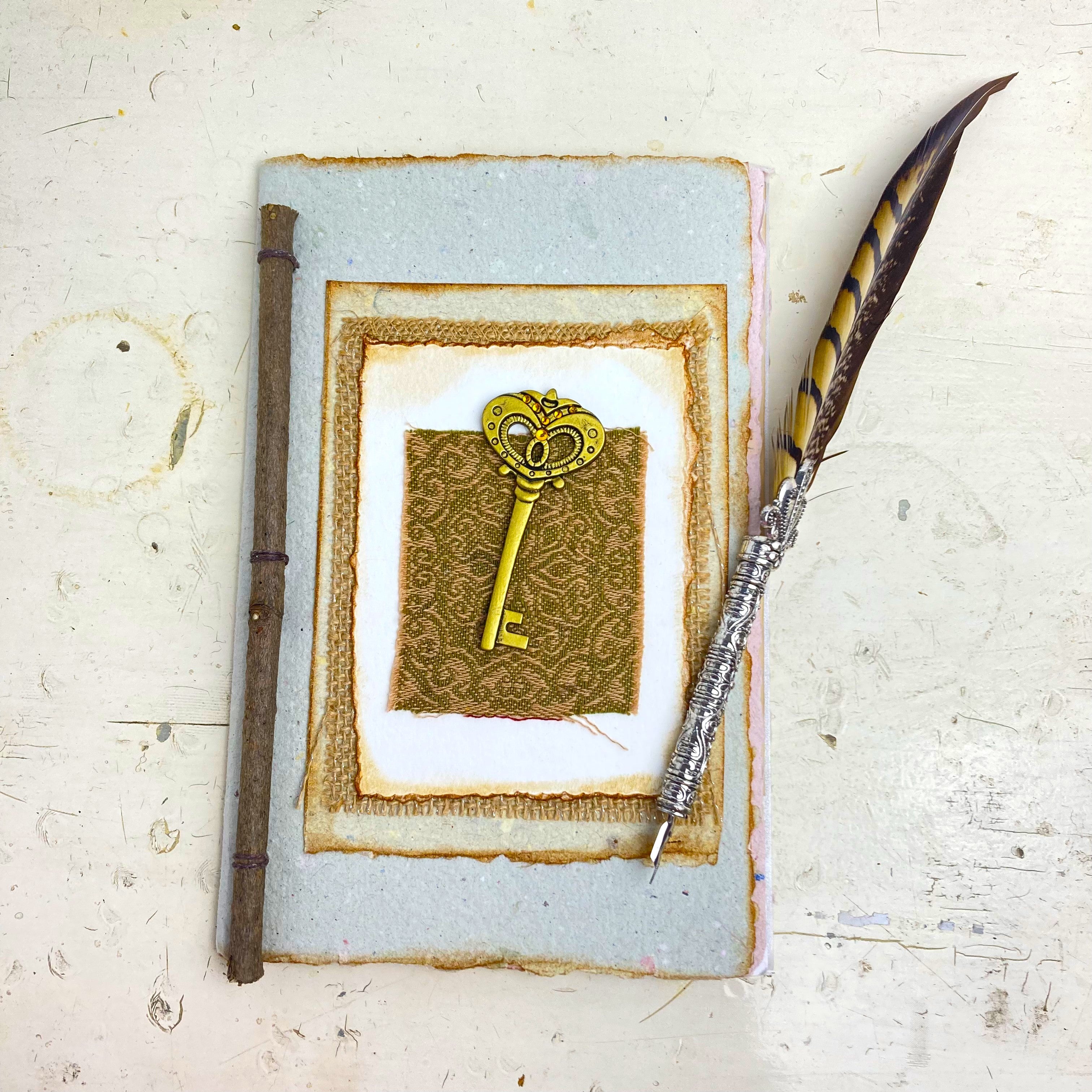 Art Journal with Handmade Paper Cover featuring a Vintage-style Key, Variety of Mixed Media Pages, Hand Sewn Binding with Stick Inserted