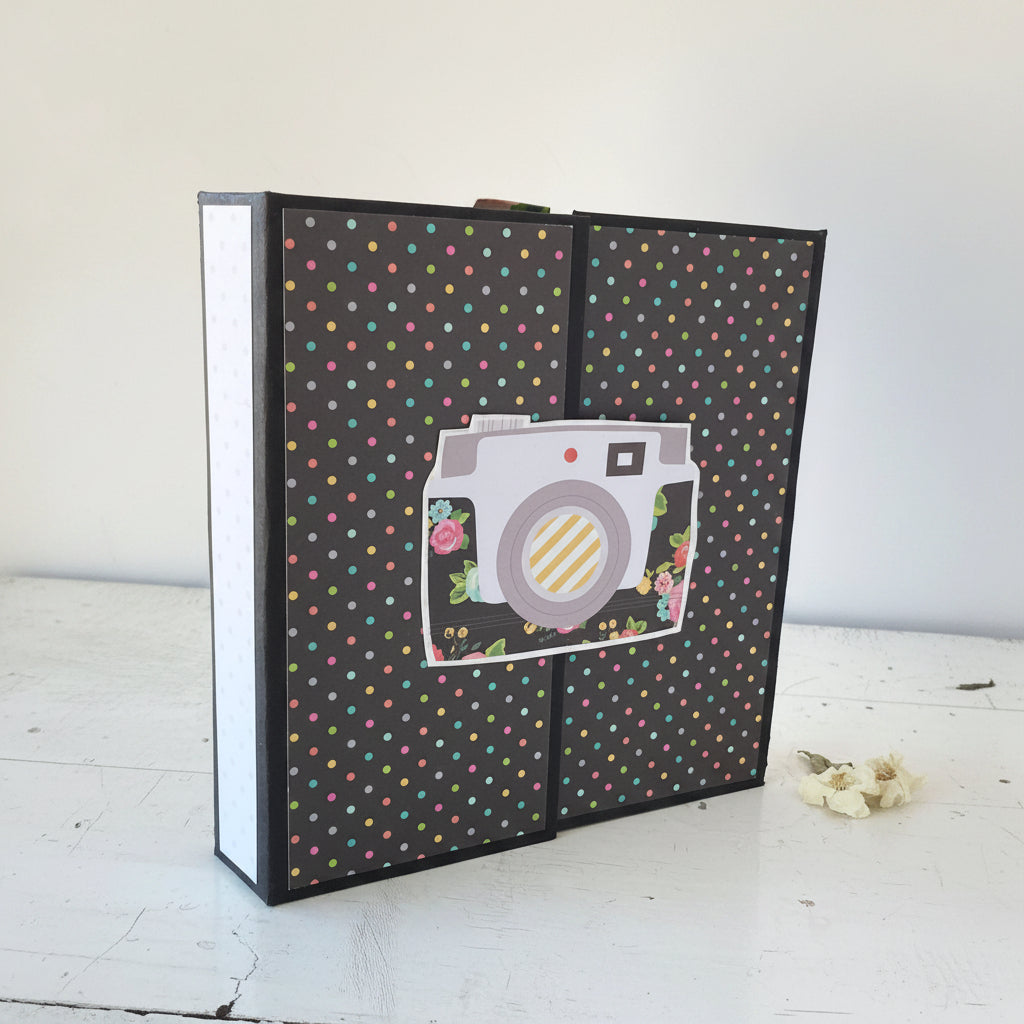 Album with a camera design and polka dot pattern on a white surface
