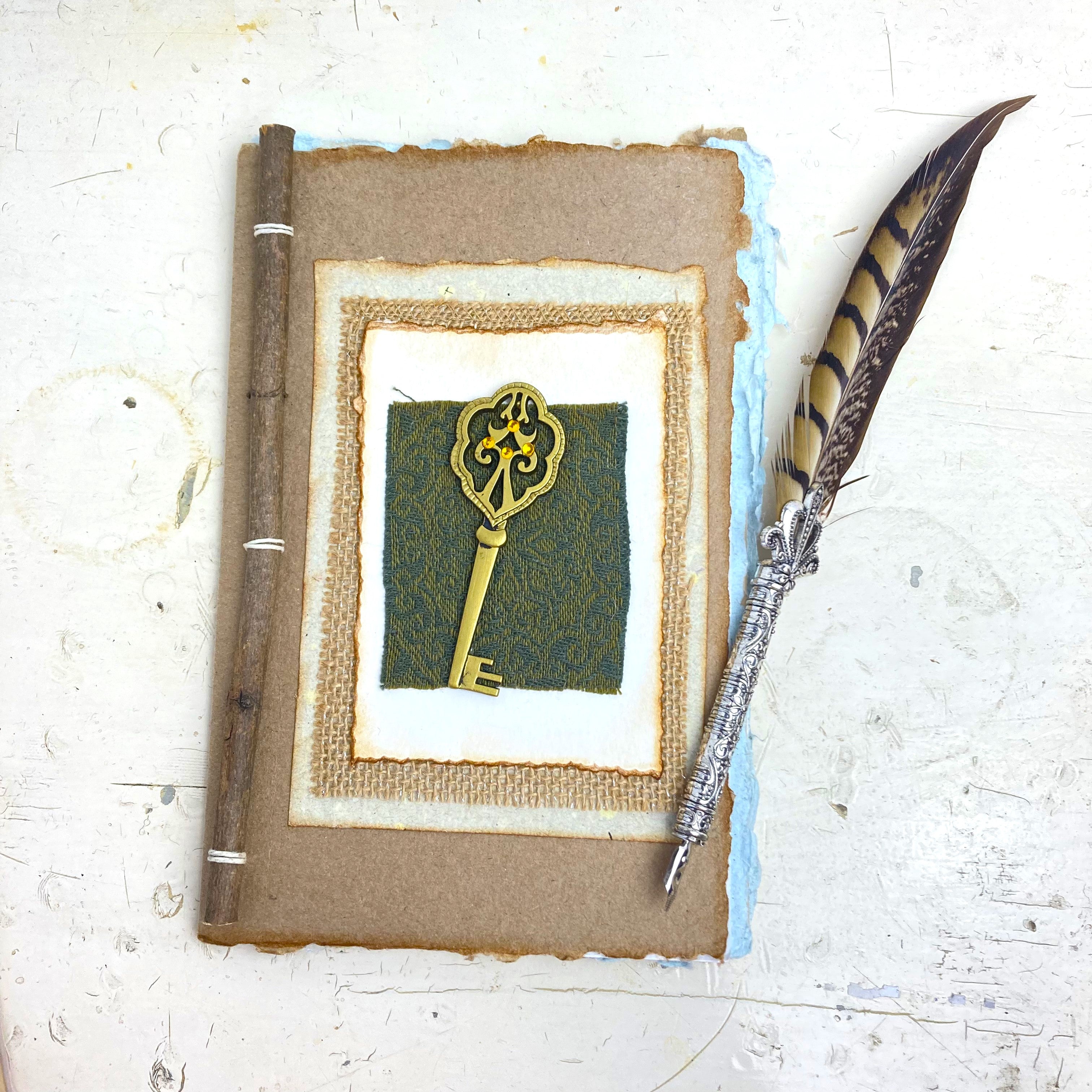 Art Journal with Handmade Paper Cover featuring a Vintage-style Key, Variety of Mixed Media Pages, Hand Sewn Binding with Stick Inserted