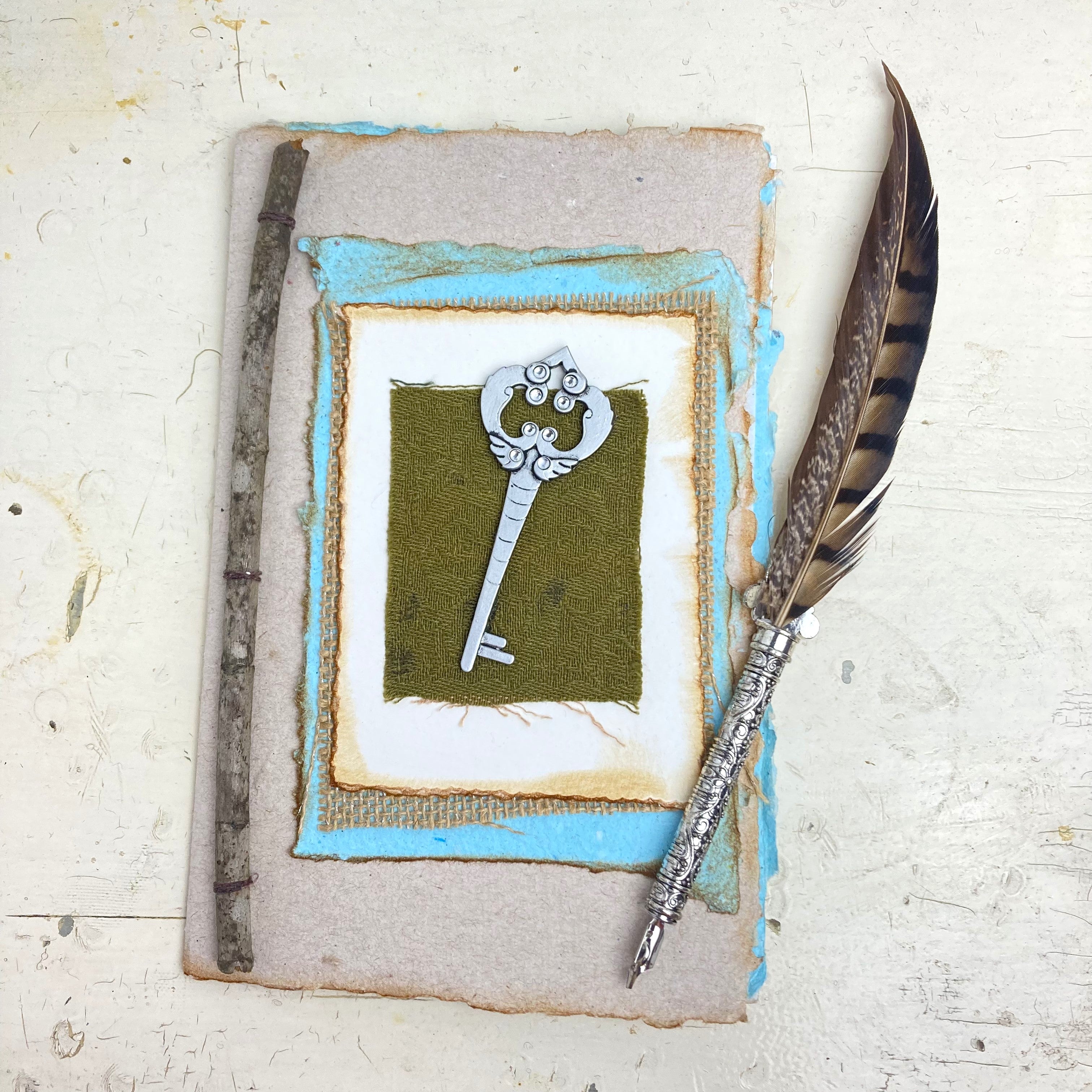 Art Journal with Handmade Paper Cover featuring a Vintage-style Key, Variety of Mixed Media Pages, Hand Sewn Binding with Stick Inserted