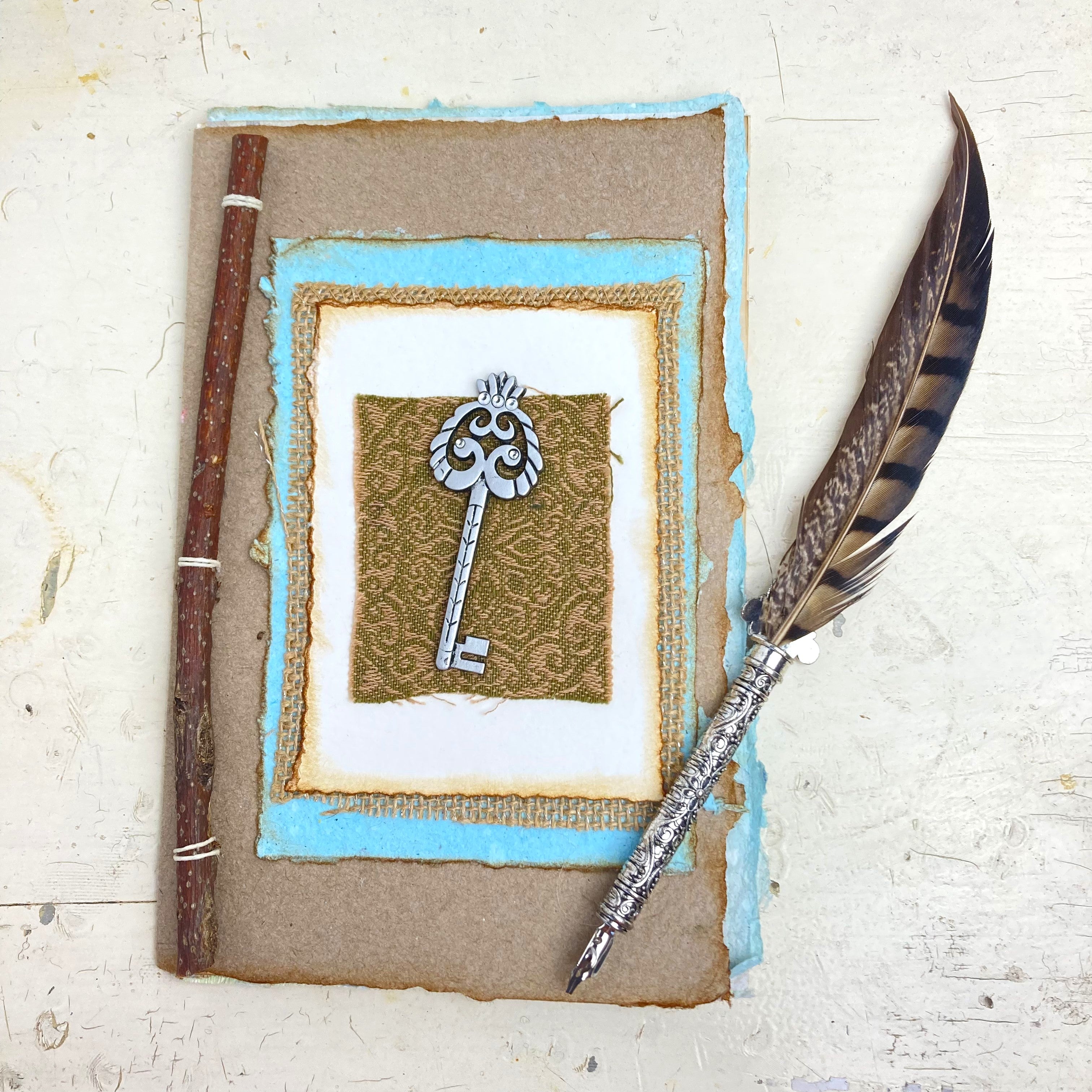 Art Journal with Handmade Paper Cover featuring a Vintage-style Key, Variety of Mixed Media Pages, Hand Sewn Binding with Stick Inserted