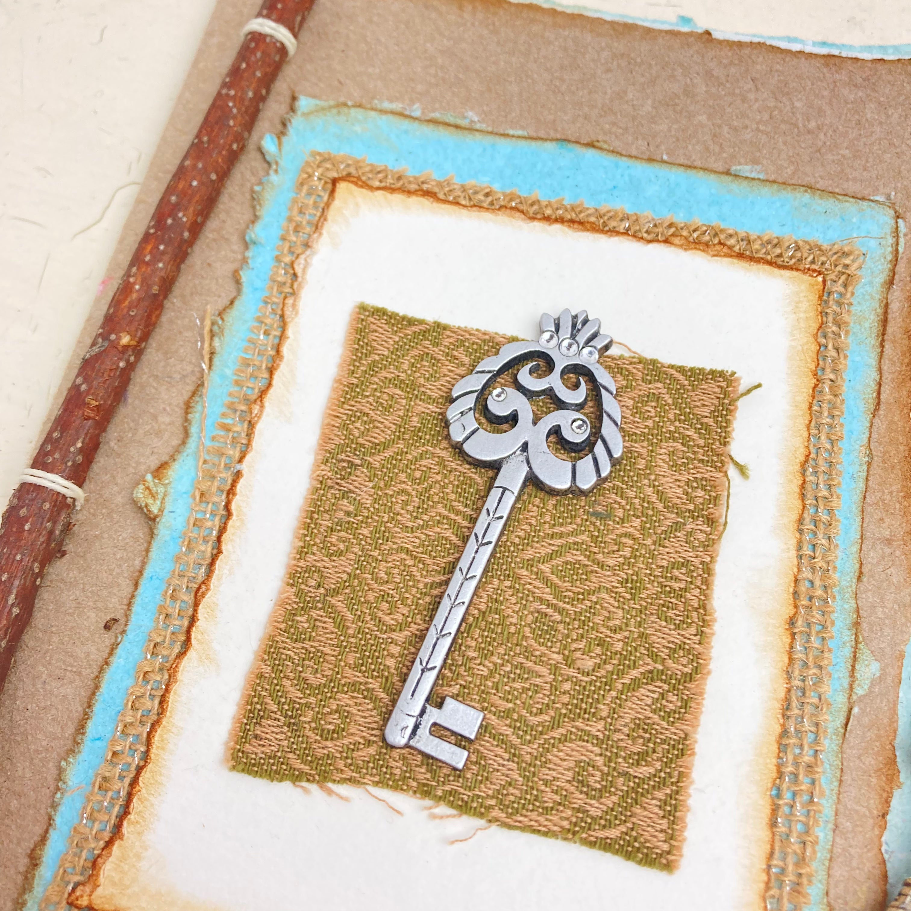 Art Journal with Handmade Paper Cover featuring a Vintage-style Key, Variety of Mixed Media Pages, Hand Sewn Binding with Stick Inserted