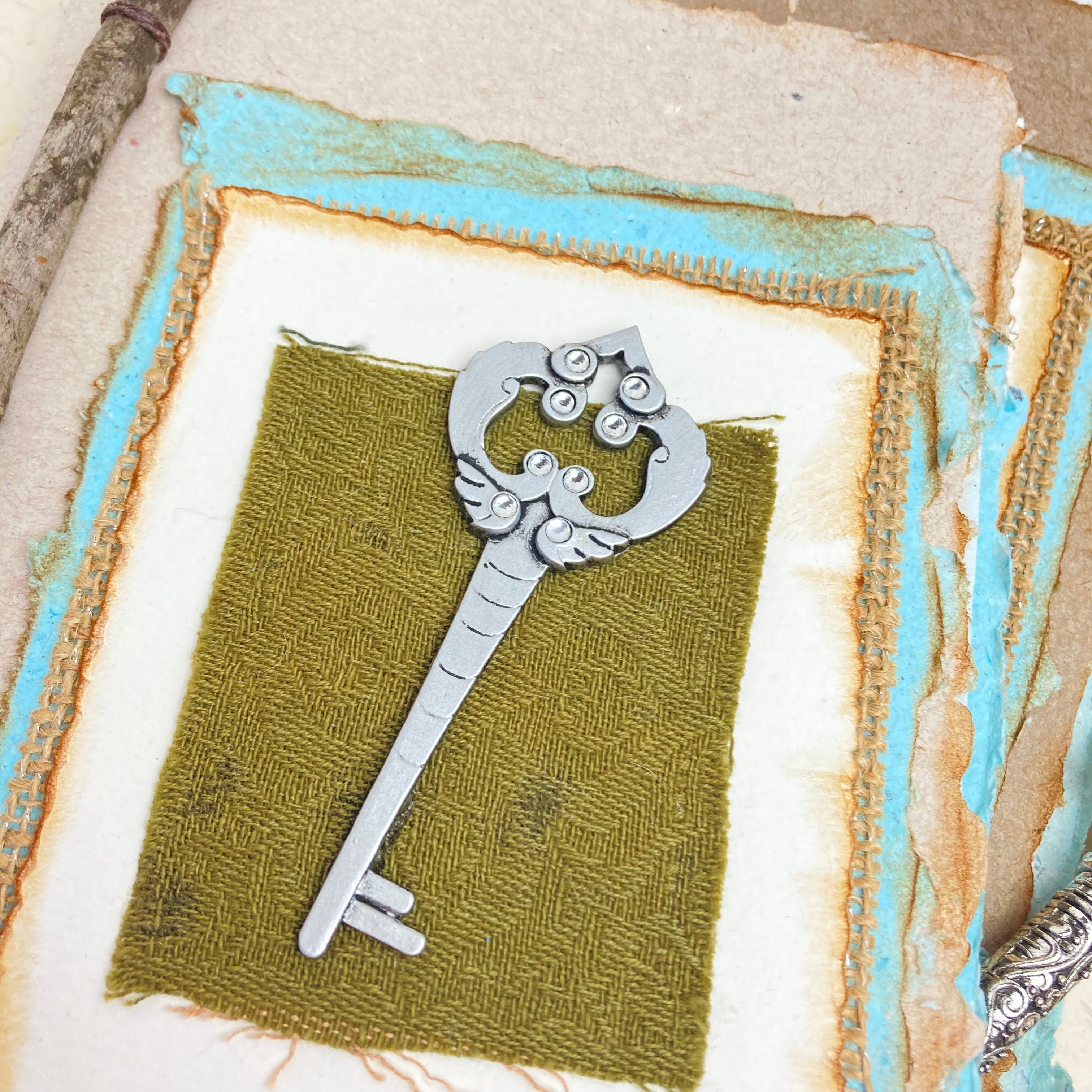 Art Journal with Handmade Paper Cover featuring a Vintage-style Key, Variety of Mixed Media Pages, Hand Sewn Binding with Stick Inserted