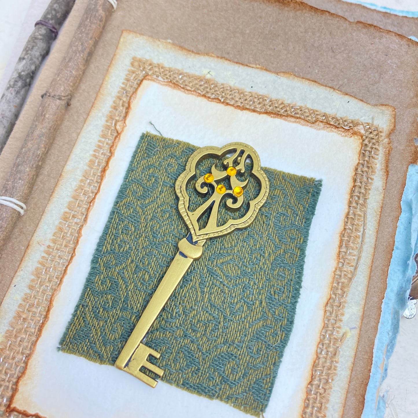 Art Journal with Handmade Paper Cover featuring a Vintage-style Key, Variety of Mixed Media Pages, Hand Sewn Binding with Stick Inserted